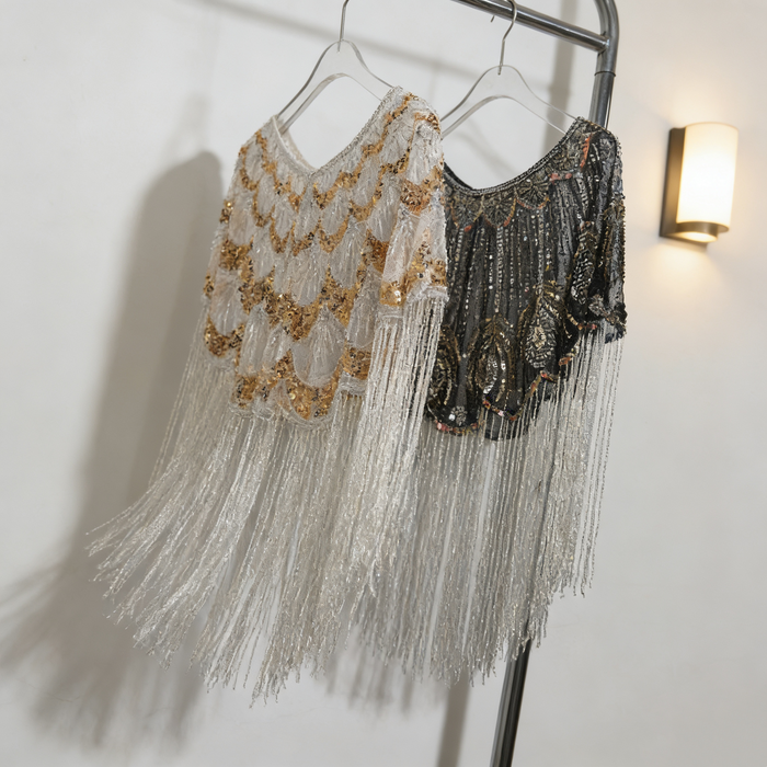 Luxury handcrafted bridal capelet with shimmering sequins, bead embroidery and flowing fringe in elegant ivory.