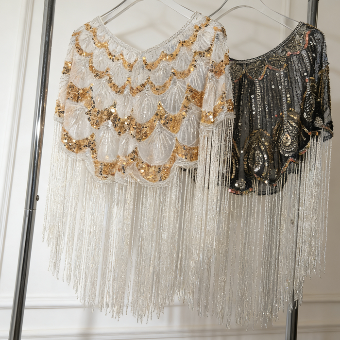 Luxury handcrafted bridal capelet with shimmering sequins, bead embroidery and flowing fringe in elegant ivory.