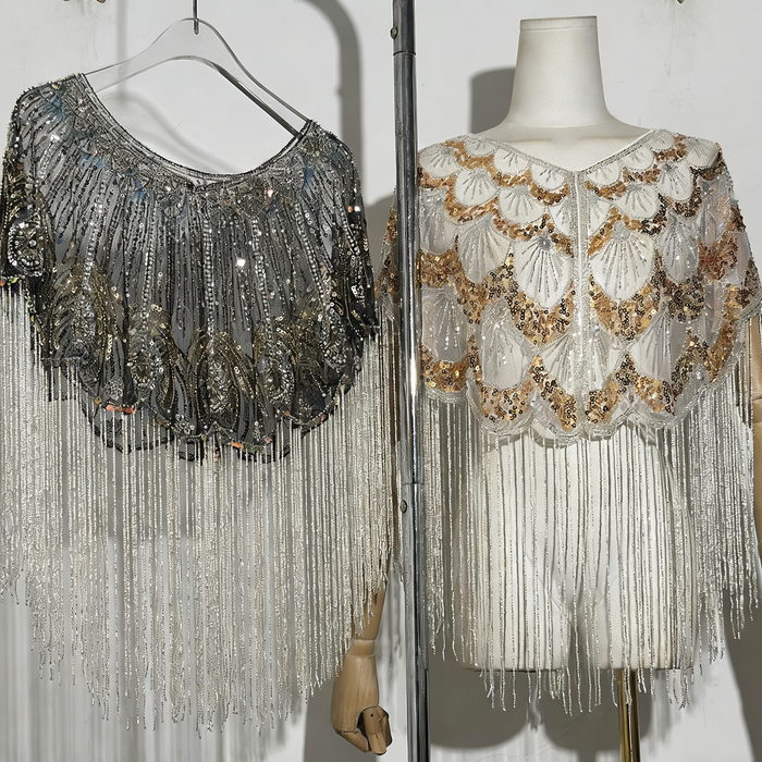 Luxury handcrafted bridal capelet with shimmering sequins, bead embroidery and flowing fringe in elegant ivory.