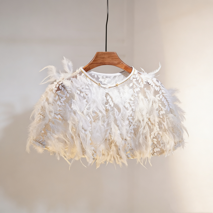 Luxury feather bridal capelet featuring embroidered leaf tulle and soft white feathers for an elegant wedding look.