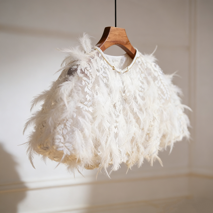 Luxury feather bridal capelet featuring embroidered leaf tulle and soft white feathers for an elegant wedding look.