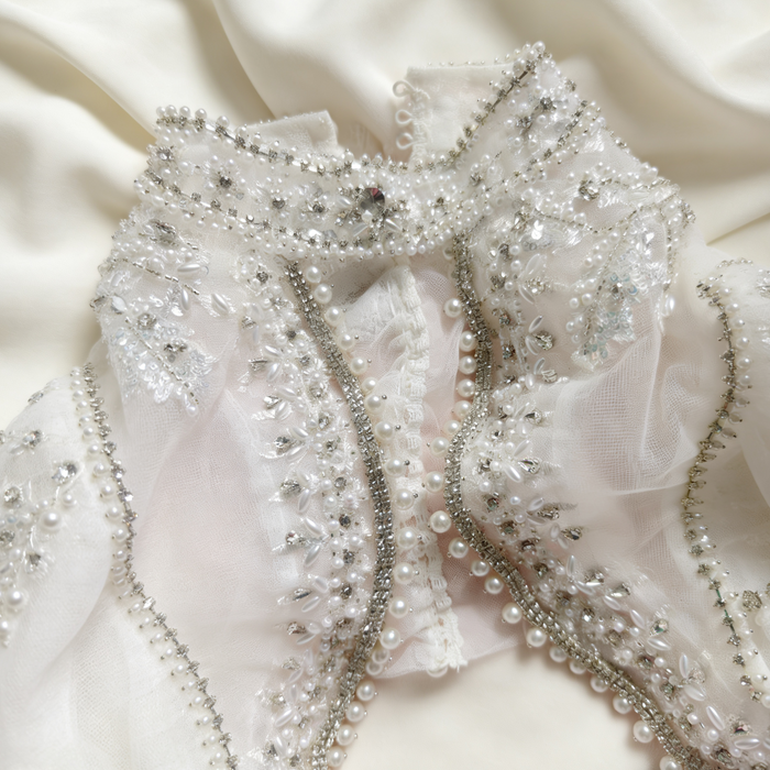 Luxury bridal capelet with high neckline, hand embroidered tulle, pearls, crystals and sparkling crystal fringe.