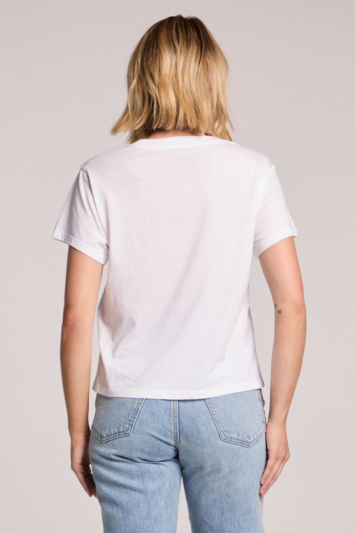 Back view of a woman wearing the Chaser  Mallorca Beach Club Tee on a neutral background
