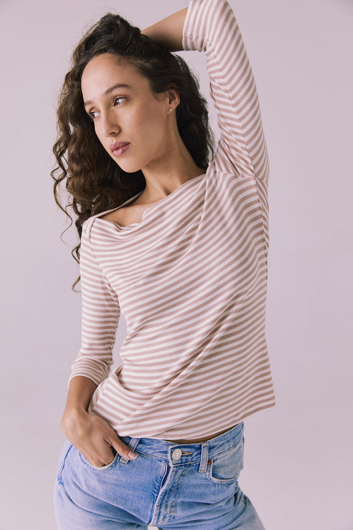 Dynamic front angle of Chaser Brand Malynne Khaki Stripe Tee with model lifting arm to show neckline movement