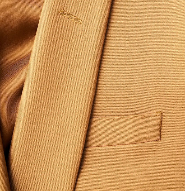 Close-up of marigold tuxedo jacket lapel, buttonhole, and welt pocket