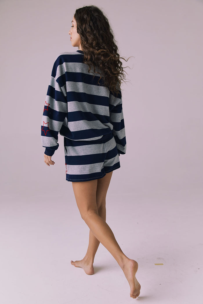 Back walking view of Chaser Brand Maritime Stars Shorts in Heather Grey Stripe showing movement and soft drape