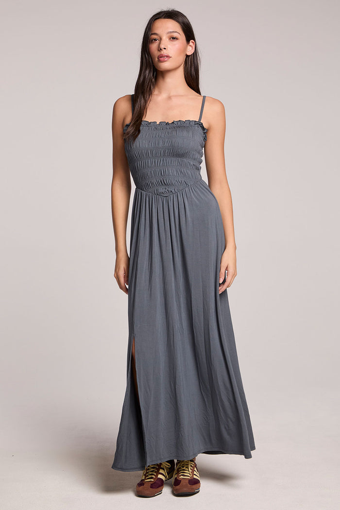 Front view of a woman wearing the Chaser Future Grey Marquise Dress and sneakers on a neutral background