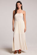 Front view of a woman wearing the Chaser Coconut Milk Marquise Dress and sneakers on a neutral background