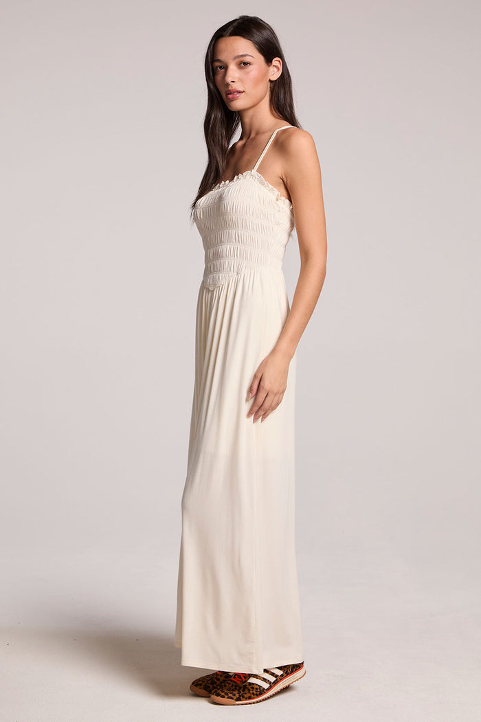 Side angle view of a woman wearing the Chaser Coconut Milk Marquise Dress on a neutral background