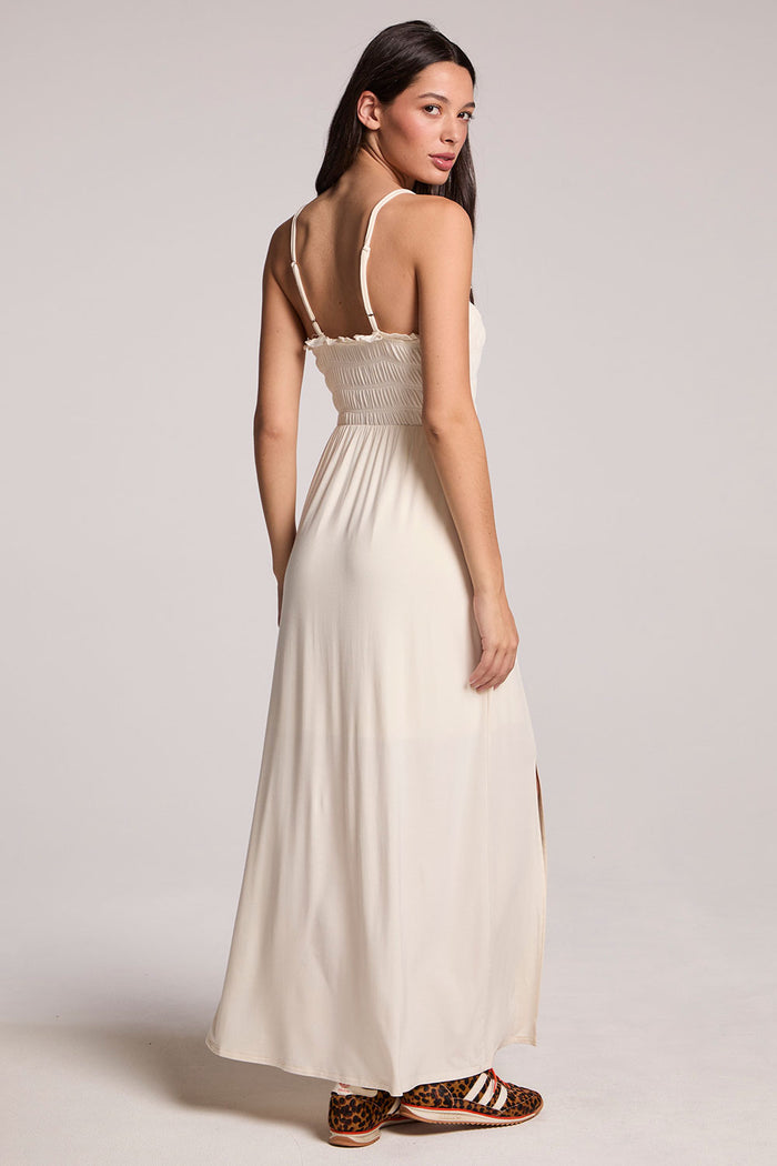Back view of a woman wearing the Chaser Coconut Milk Marquise Dress on a neutral background, looking over one shoulder