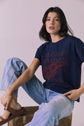 Seated editorial view of Chaser Brand Martha’s Vineyard Tee in Navy showing relaxed fit and vintage lobster graphic