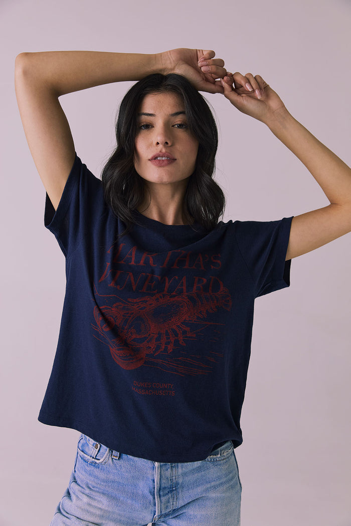 Front view of Chaser Brand Martha’s Vineyard Tee in Navy with arms raised highlighting soft drape and coastal graphic design