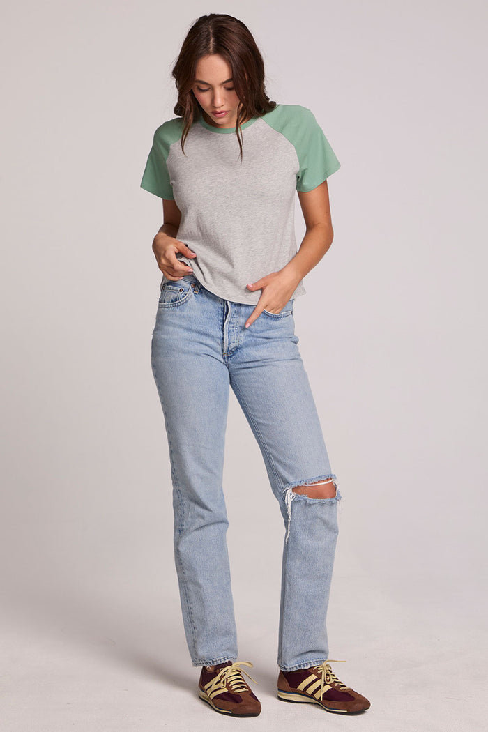 A full body front view of a woman wearing the Chaser Maybel Verdelle and Heather Grey Raglan Tee on a neutral background