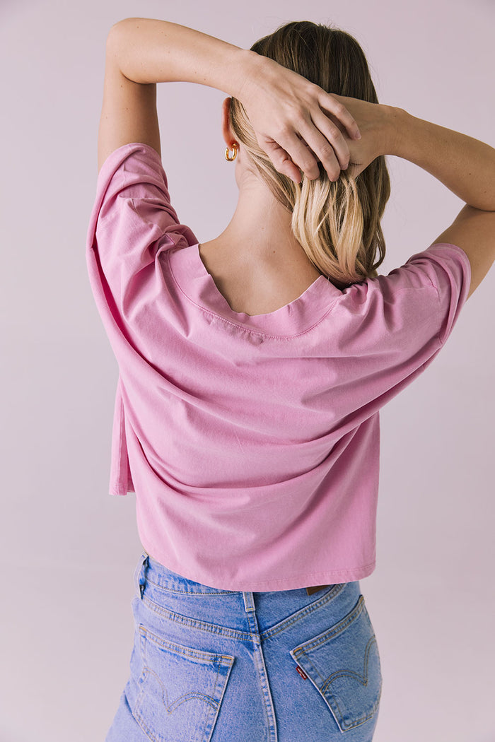 Back detail of the Chaser Brand Mazzy Bubblegum Tee with model lifting her hair to show neckline shape