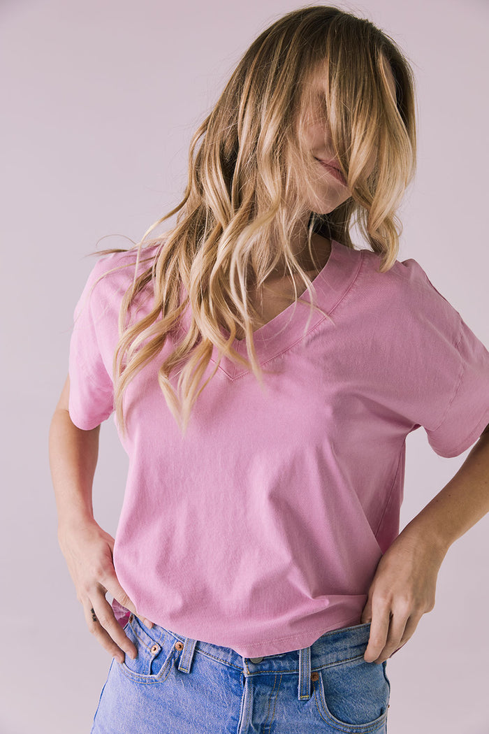 Front angle of the Chaser Brand Mazzy Bubblegum Tee with model’s hair partially covering her face, showing relaxed movement