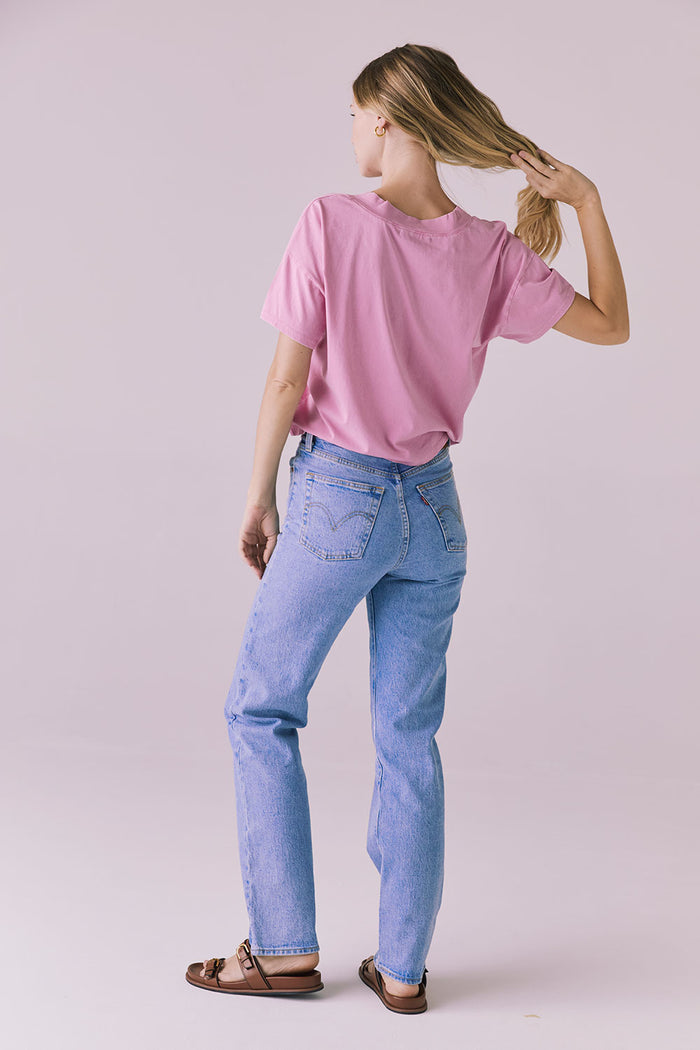 Full body back view of the Chaser Brand Mazzy Bubblegum Tee styled with straight-leg jeans and sandals