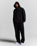Displays a model wearing the Black 'Hoodrich' branded men's Aegis Full Tracksuit