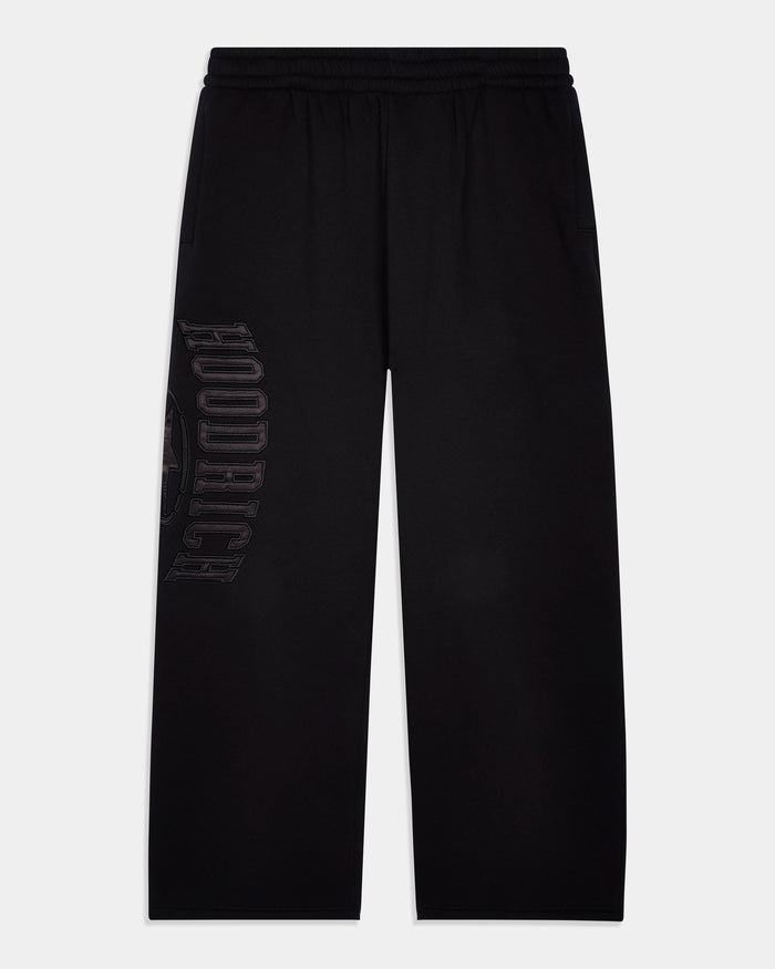 Black wide-leg sweatpants with a drawstring waistband and a tonal vertical 'HOODRICH' logo printed on the left leg, shown against a light gray background.