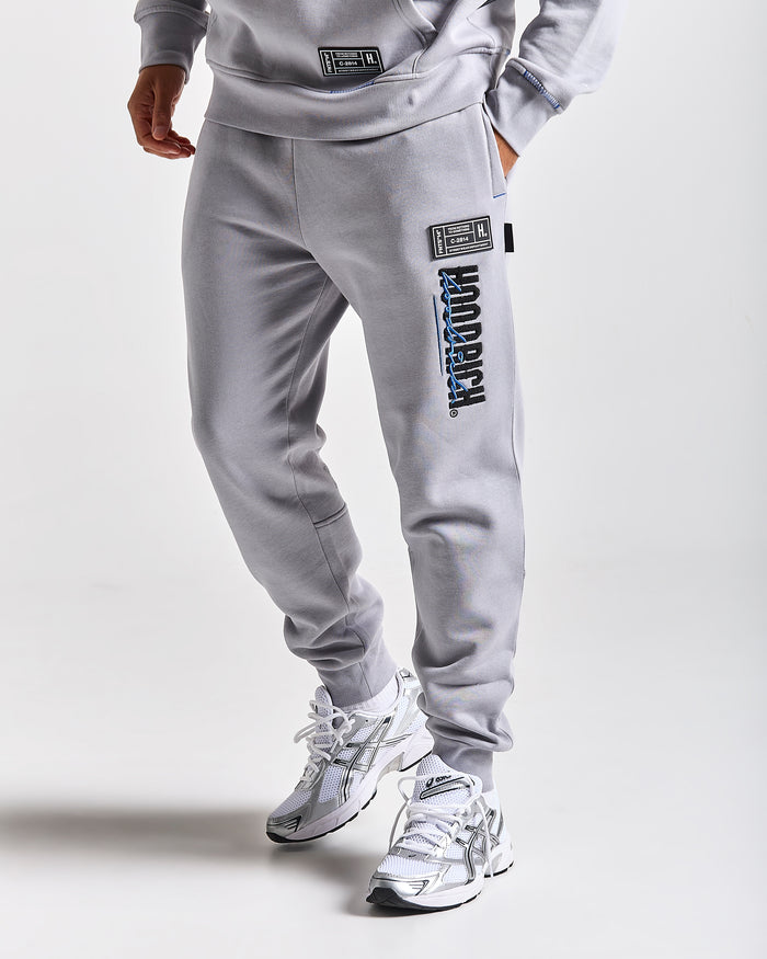 Displays a model wearing the Grey 'Hoodrich' branded men's blend Full Tracksuit