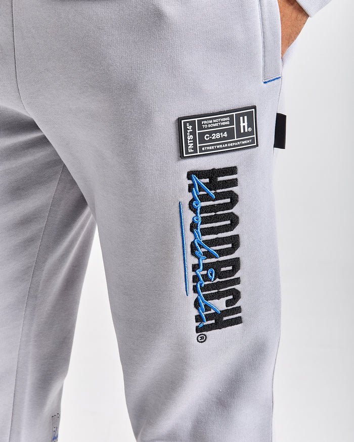 Displays a model wearing the Grey 'Hoodrich' branded men's blend Full Tracksuit