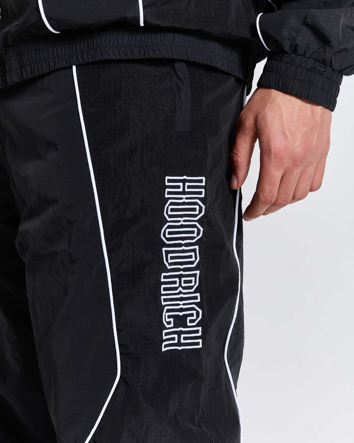 Black pants with 'Hoodrich' branding on a white background