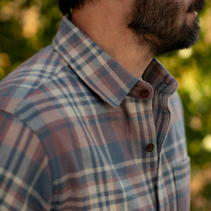 A man with a beard in a Pladra Men's Every Day Elite Flannel Shirt in Coral Grey, shown outdoors from neck to chest.
