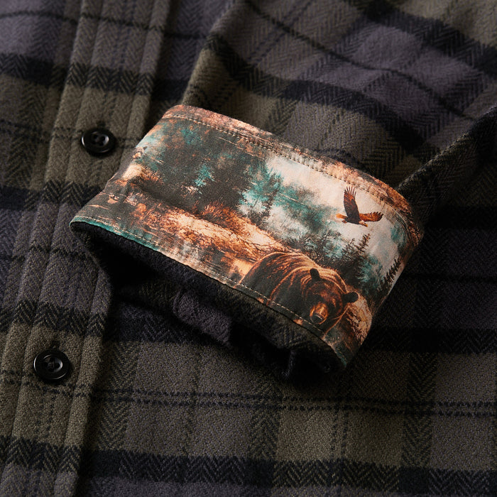 Closeup of Pladra Men's Every Day Elite Flannel Shirt- Storm Black with bear and eagle forest print inside the cuff.