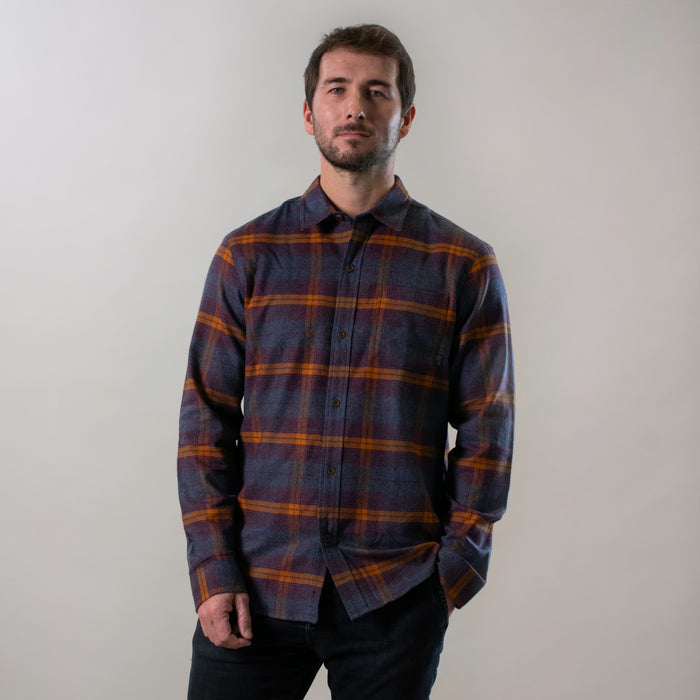 Man with short hair and beard wears Pladra Men's Every Day Flannel Shirt–Portsmouth Blue Heather, hand in pocket.