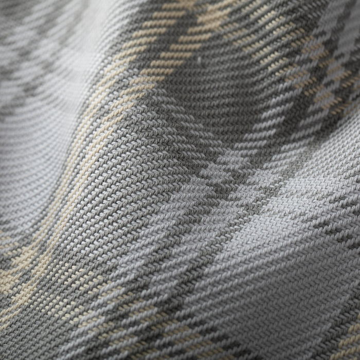 Close-up of the Men's Fireside Flannel - Quartz Grey, featuring soft, organic cotton in a gray, white, and beige plaid with a diagonal checkered pattern and detailed stitching.