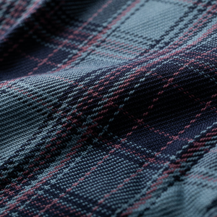 Close-up of Pladra Men's Fireside Flannel in Riffle Blue, showing detailed plaid texture and diagonal folds.