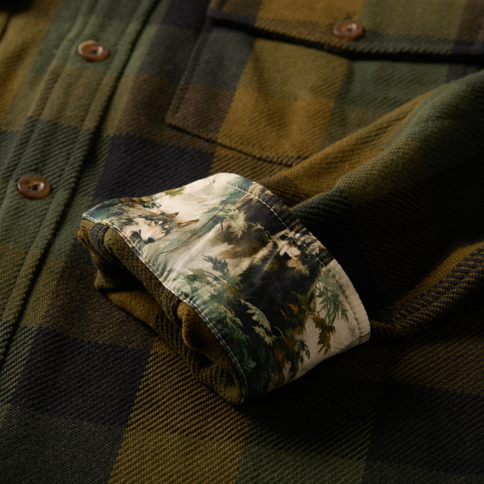 Close-up of Pladra Men's Fireside Flannel - Woodland Green, sleeve cuff flipped to show floral print lining.