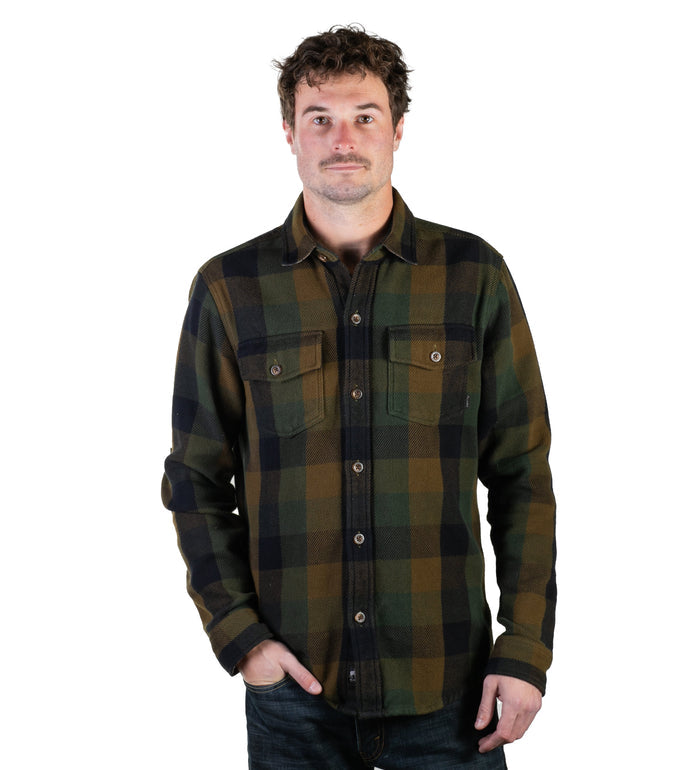 Man wearing Pladra Men's Fireside Flannel in Woodland Green, standing against a white background.