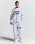 Man wearing a gray 'Hood Rich' tracksuit on a white background