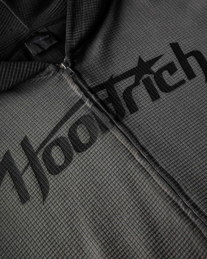 Close-up of a dark gray waffle-knit zip-up hoodie with a large black 'Hoodrich' logo printed across the chest.