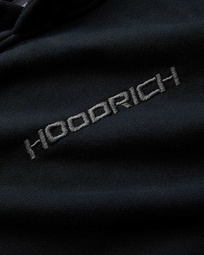 Close-up of a dark fabric with 'Hoodrich' embroidered on it.