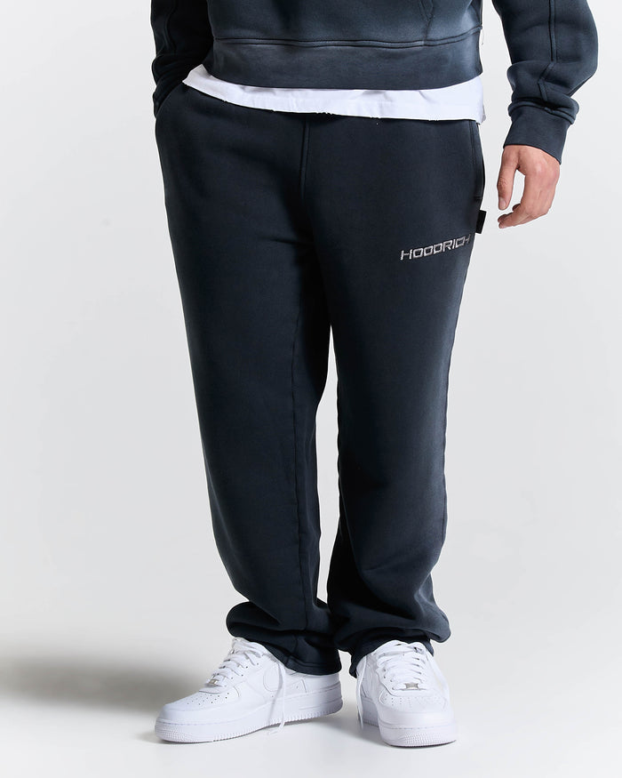 Person wearing black sweatpants with a brand logo on a white background
