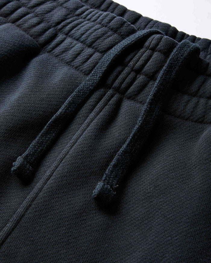Dark gray fleece pants with drawstring on a light gray background