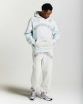 Displays a model wearing the Grey 'Hoodrich' branded men's Inkline Full Tracksuit