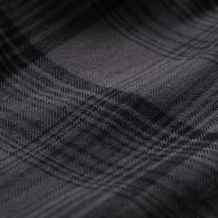 Close-up of Pladra Men's Northwood Sherpa Insulated Flannel Jacket-Deadwood Black shows soft, textured plaid fabric.