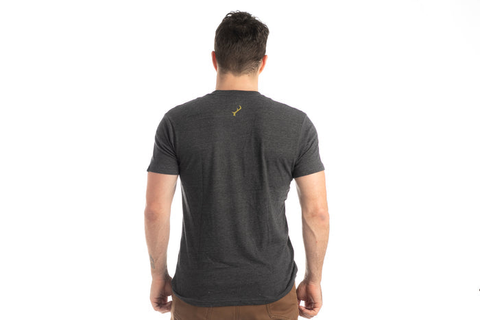 Man wearing Pladra Men's Quail Tee in Charcoal Grey Heather, shown from the back against a white background.
