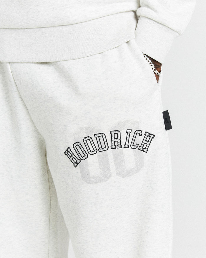 White sweatpants with 'Hoodrich' branding on a white background