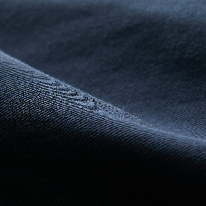 Close-up of the Men's Sequoia Chore Coat in Midnight Blue, showing textured fabric with visible weave and soft folds—ideal for men’s workwear, reminiscent of classic cotton twill with gentle waves and deep shadows.