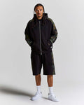 Displays a model wearing the Black Camo 'Hoodrich' branded men's Shade Matching Shorts Set