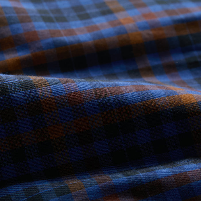 Close-up of Pladra Men's Short Sleeve Tailwinds Shirt - Lagoon Blue, showing plaid poplin fabric texture and gentle folds.