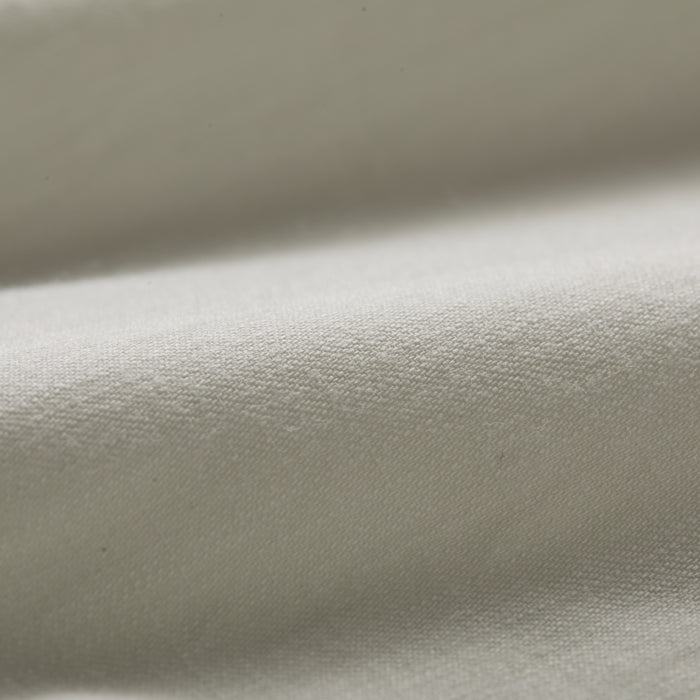 Close-up of the Men’s Short Sleeve Tailwinds Shirt in Sand White Chambray, showcasing its soft, smooth cotton fabric, detailed weave, and gentle folds that highlight subtle shadows on the surface.