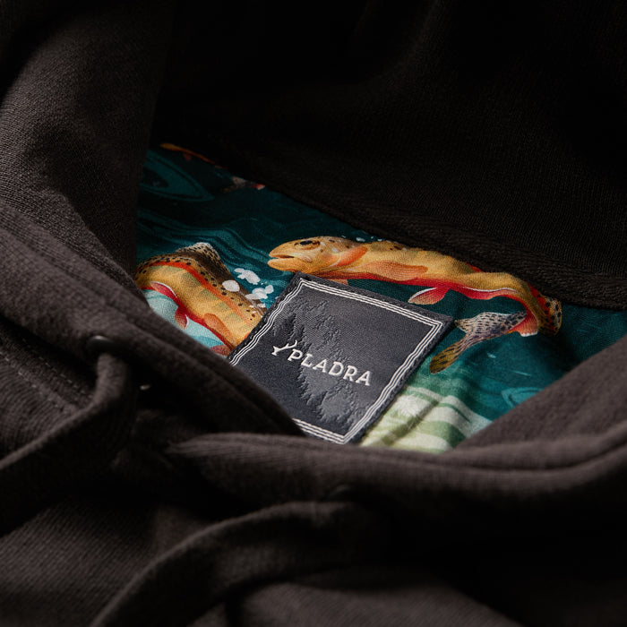 Close-up of a Pladra Men's Sierra Hoodie- Charcoal Black tag with colorful fish pattern lining inside the hood.