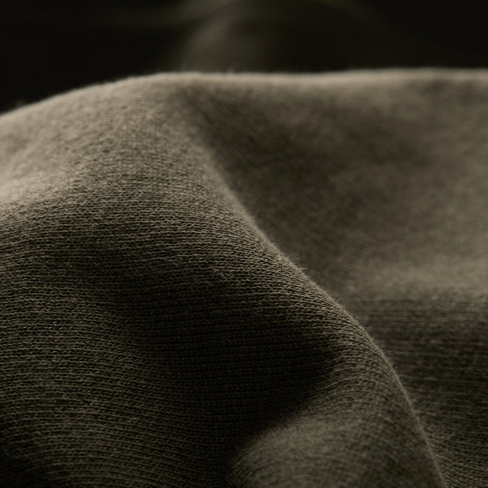 Close-up of the soft, textured pine green fabric on the Men's Sierra Hoodie, highlighting its gentle folds, depth, and smoothness.