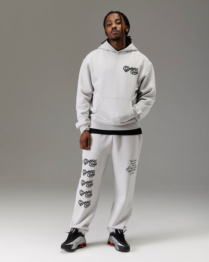 Displays a model wearing the grey 'Goodrich' branded men's winner's Circle Full Tracksuit