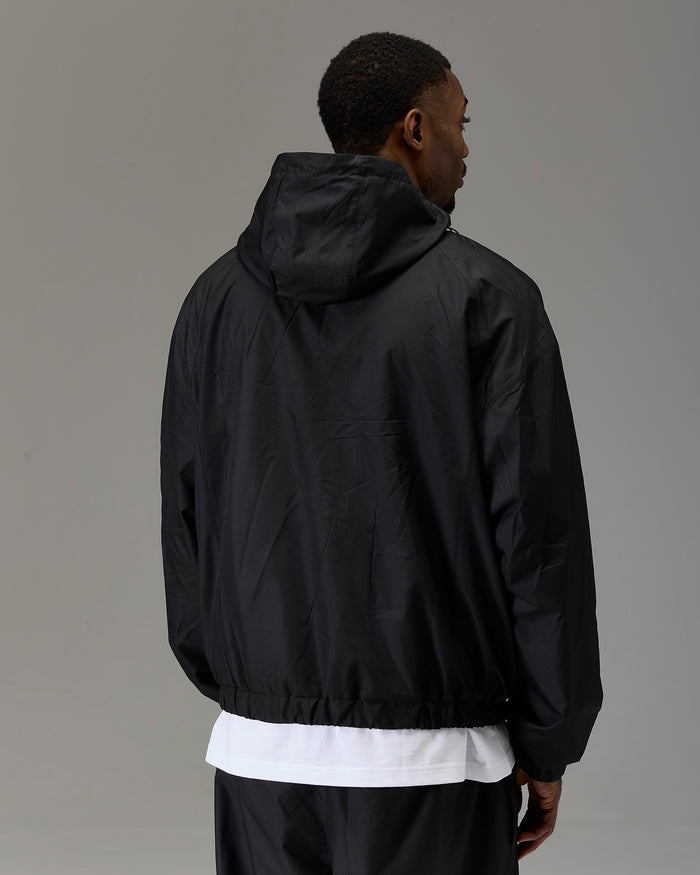 Displays a model wearing the Black 'Hoodrich' branded Men's The Winner's Circle Ripstop Woven Full Tracksuit