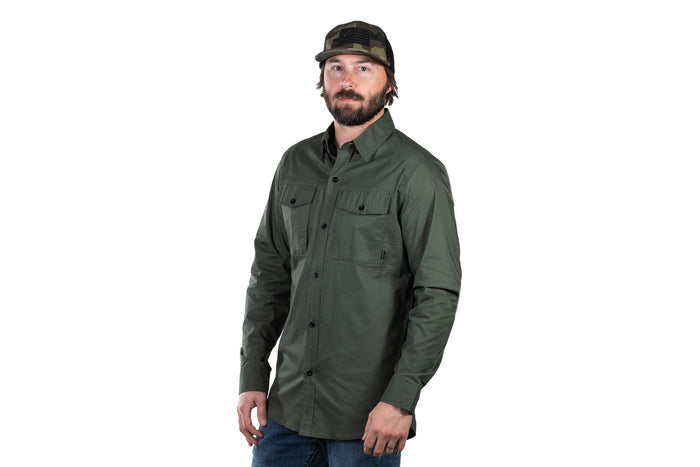 Man with a beard in a Pladra Men's Yuba Fishing Shirt - Kombu Green, blue jeans, and a dark cap.